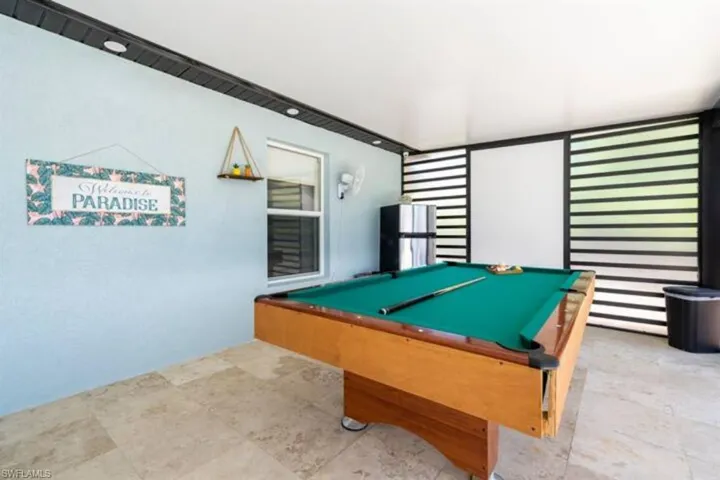 Recreation room with light tile patterned floors and billiards
