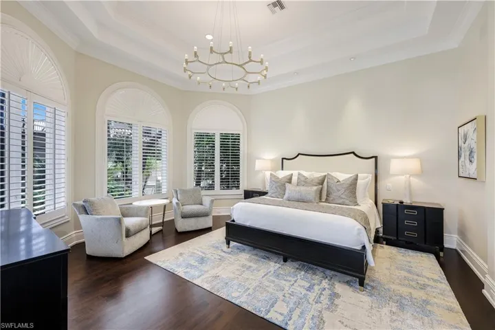 The completely updated primary bedroom suite, located on the first floor, will be your retreat at days. The suite offers gorgeous NEW wood flooring and a water view. This room is privately located on the northwestern side of the home.