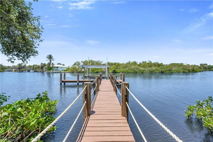 Private dock with a high-capacity boat lift, offering direct Gulf access and a picturesque setting along the peaceful river. Boat, fish, enjoy the sunset views!