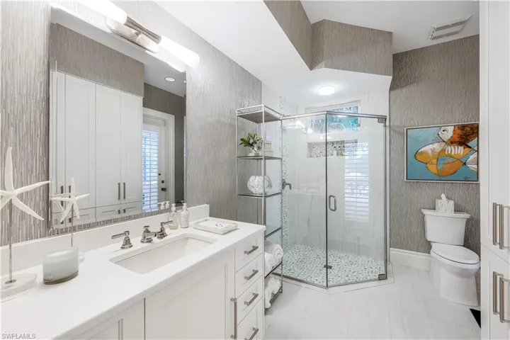 Elegant guest bath with walk-in shower and plenty of storage space.