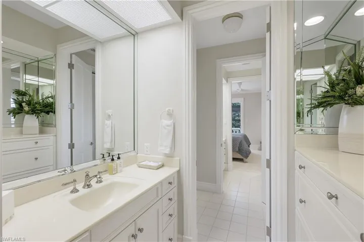 Jack and Jill bathroom with two separate vanity/storage areas.