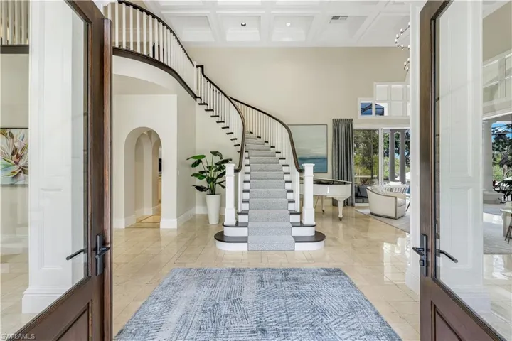 Enter through the grand foyer. Highlights include volume ceilings, a custom staircase and river views.