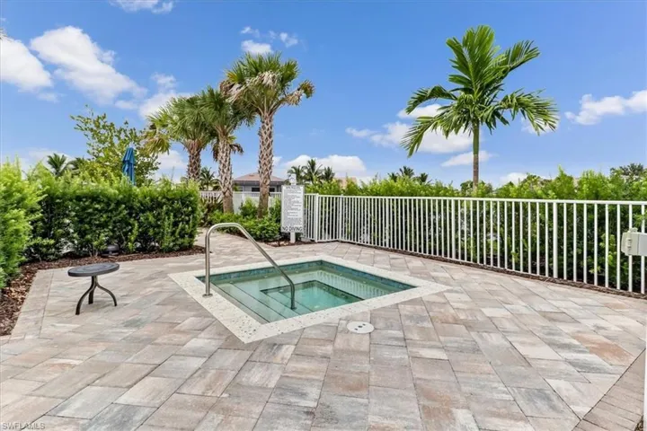 View of pool with a hot tub and a patio area