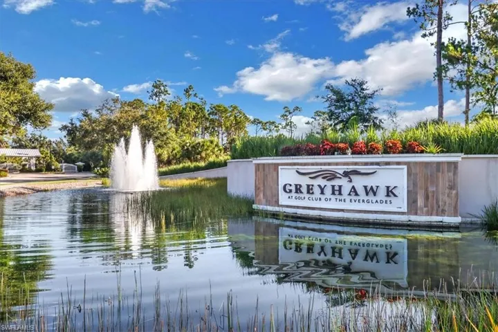 Community sign with a water view