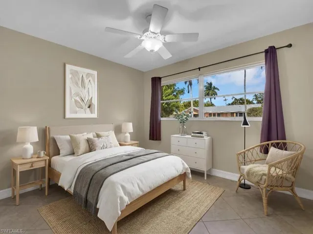 Bedroom featuring multiple windows, a ceiling fan, and light tile patterned floors