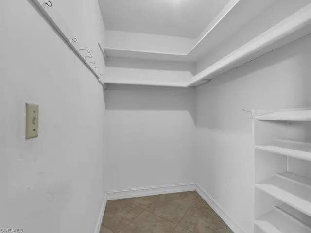 Walk in closet with light tile patterned flooring