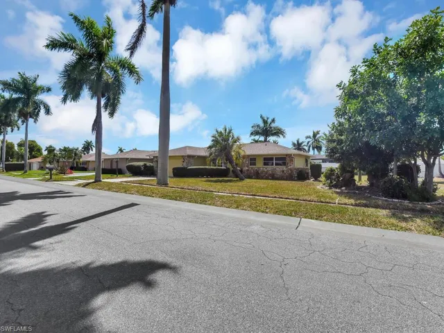 View of front of property featuring a front yard and a residential view