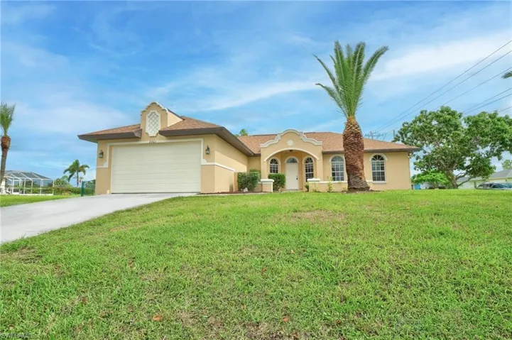 Single story home featuring a garage and a front lawn