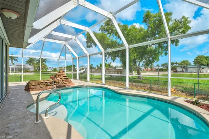 View of swimming pool with a yard and a lanai