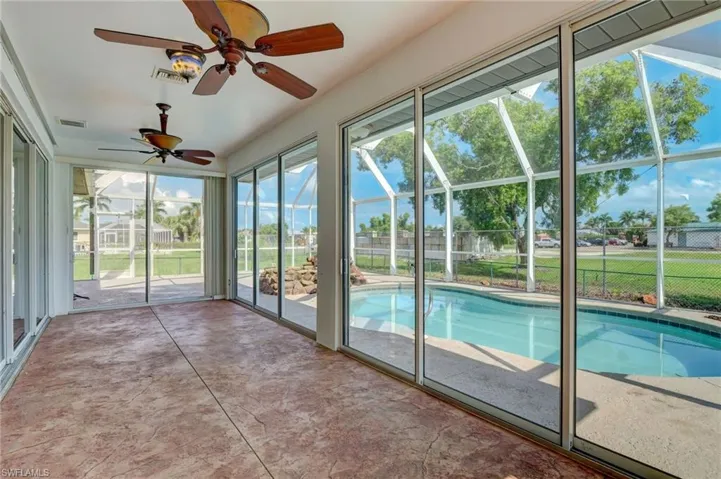 View of swimming pool featuring ceiling fan