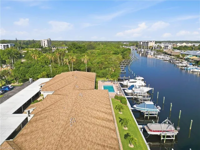Waterfront property featuring a private boat dock, multiple boat slips, and a dedicated swimming pool