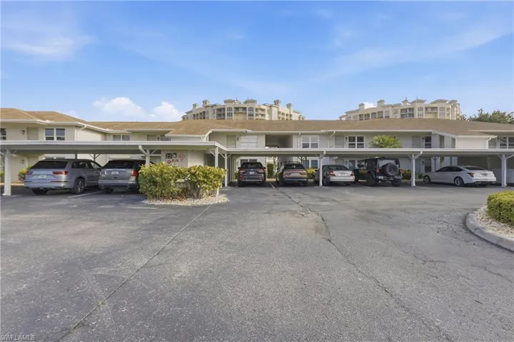 Covered parking structures with multiple spaces, featuring light-colored roofing and support columns