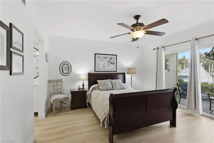 Light-toned wood-finish flooring complements the bright white walls and ceiling