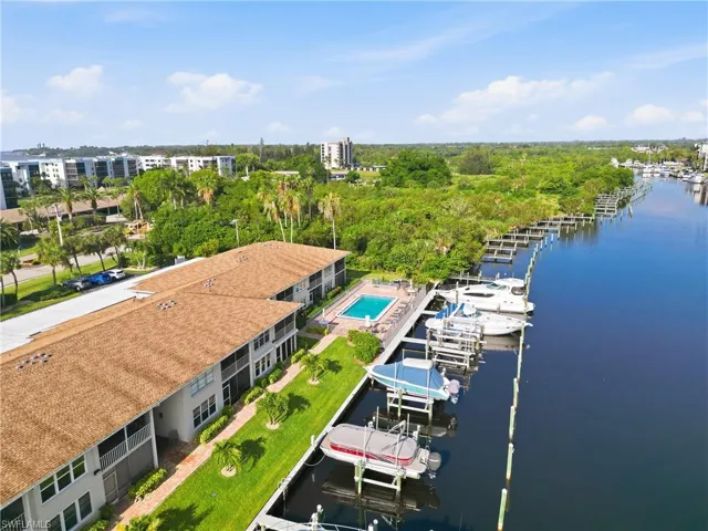 Waterfront residential buildings with private boat docks and a dedicated swimming pool