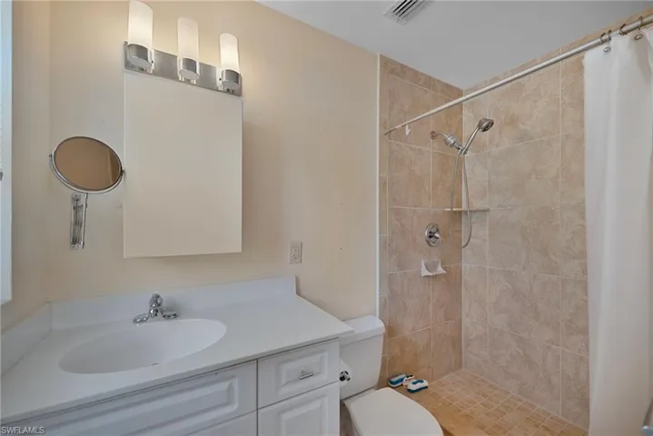 Full bath featuring a shower stall and vanity