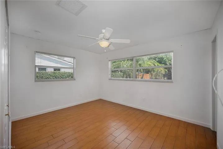 Spare room featuring light wood-style flooring and a ceiling fan