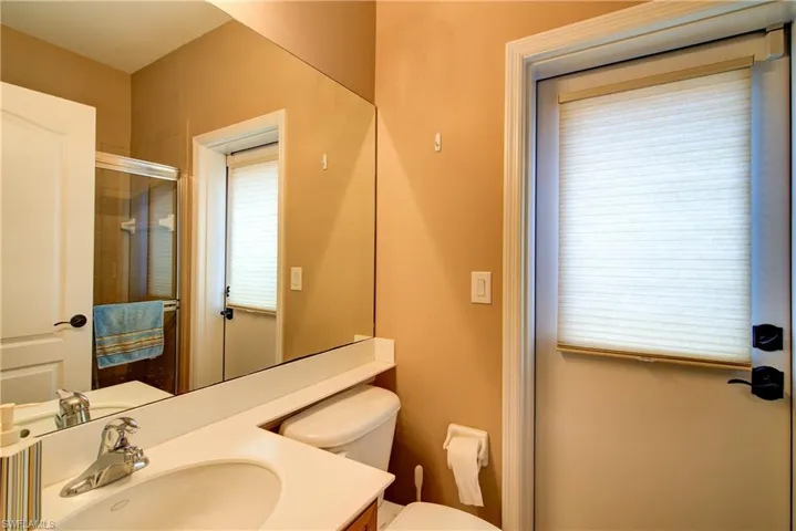 Guest bathroom downstairs with a stand-up shower & outdoor access