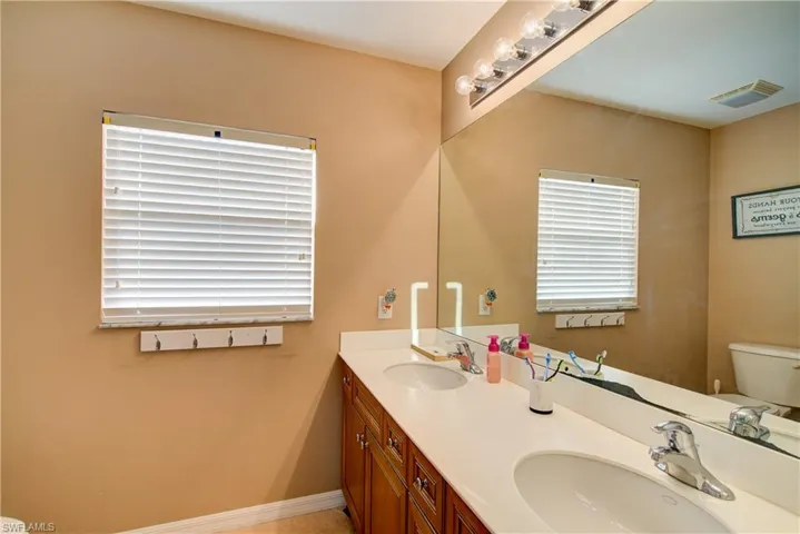 The upstairs guest bathroom with a dual vanity and a tub/shower combo