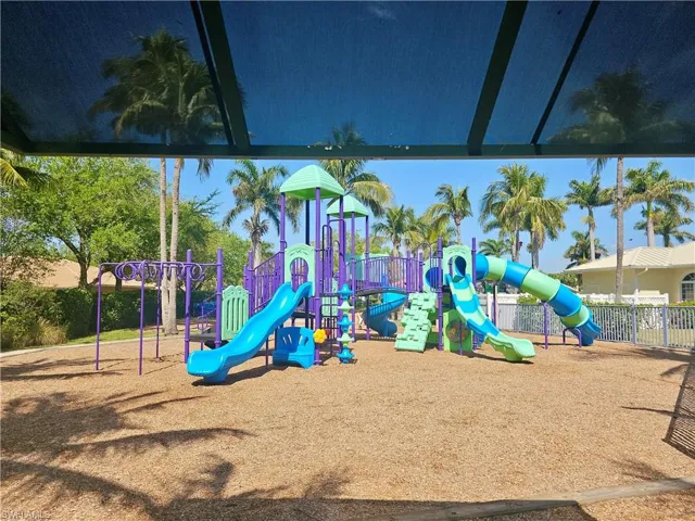 A kids playground with sunshade, conveniently located next to the pool