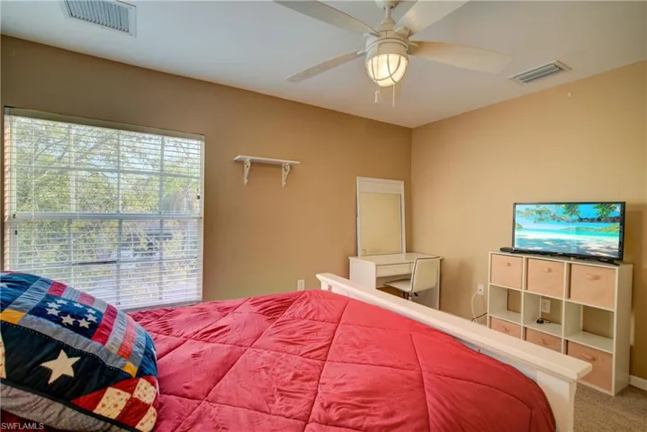A good sized bedroom with a large window
