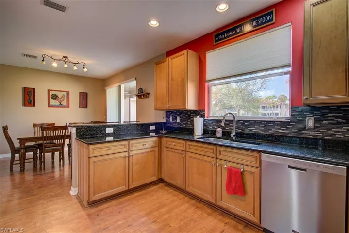 A gorgeous glass tile backsplash making for easy clean-up