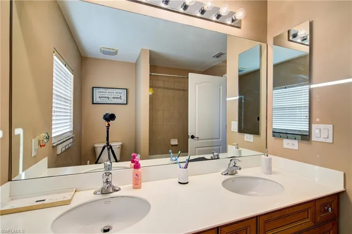 The upstairs guest bathroom with a dual vanity and a tub/shower combo