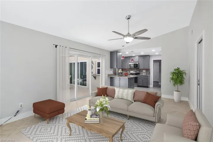 Virtually staged Family Room with impact sliding doors out to the pool area.