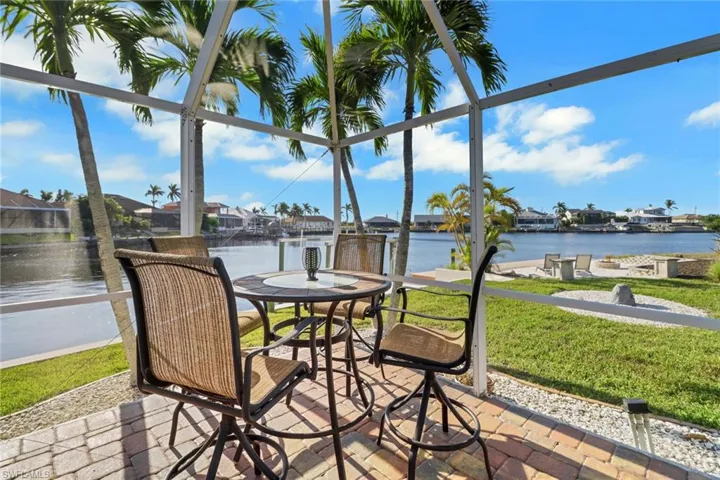 Sunroom featuring a healthy amount of sunlight and a water view