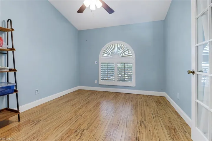 Unfurnished room featuring ceiling fan, vaulted ceiling, and light hardwood / wood-style flooring