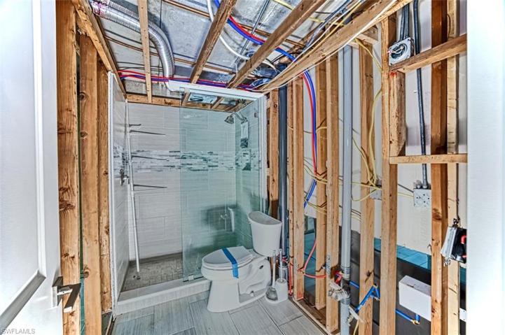 Guest bath with porcelain tile and decorative glass accent tile.