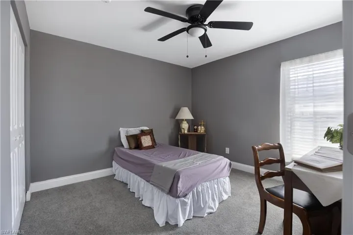 Bedroom featuring ceiling fan, carpet, and a closet