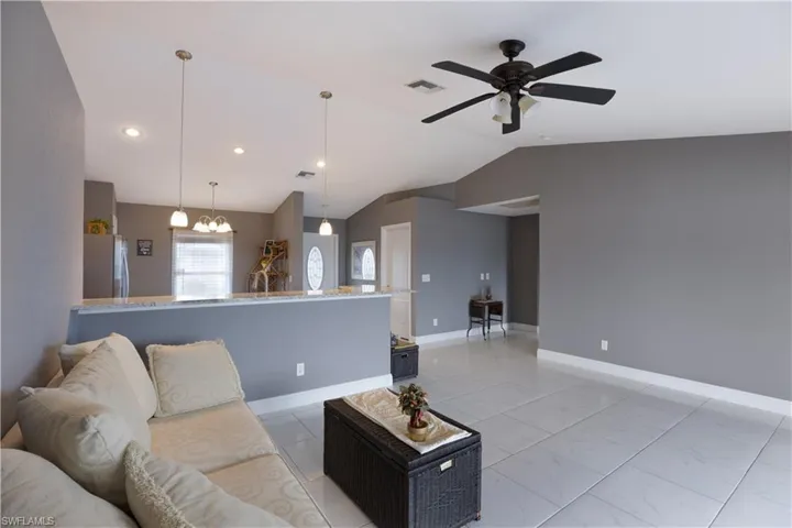 Living area featuring ceiling fan and suspended lighting