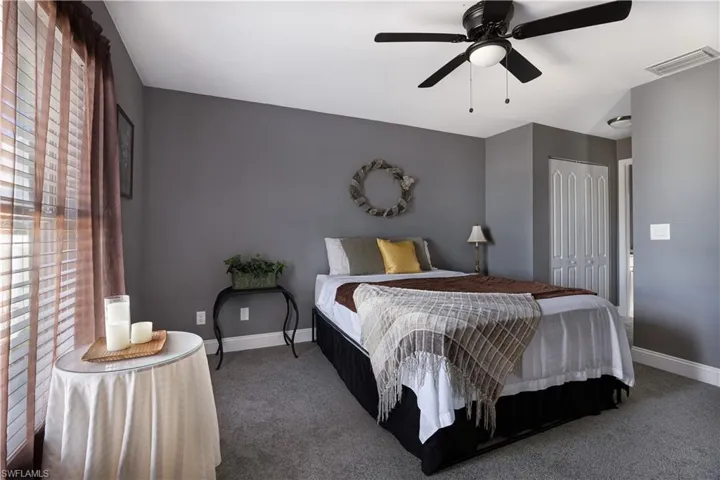 Primary Bedroom with a closet, ceiling fan, and carpet