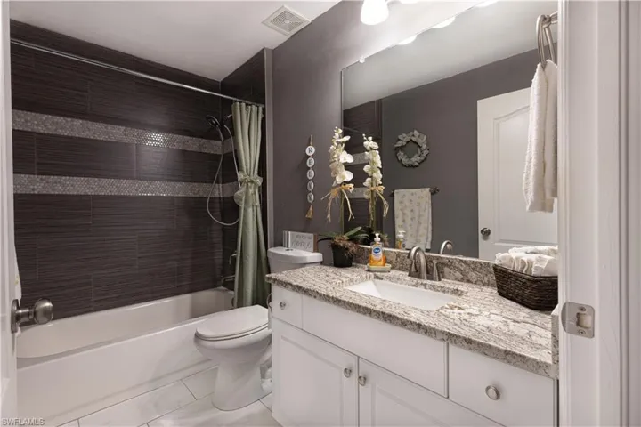 Secondary Bathroom featuring vanity and shower / tub combo with curtain