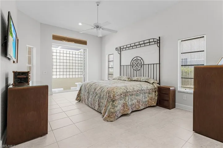 Bedroom with light tile patterned floors, ceiling fan, and recessed lighting