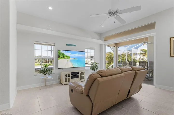 Living room with plenty of natural light, ceiling fan, light tile patterned floors, and recessed lighting
