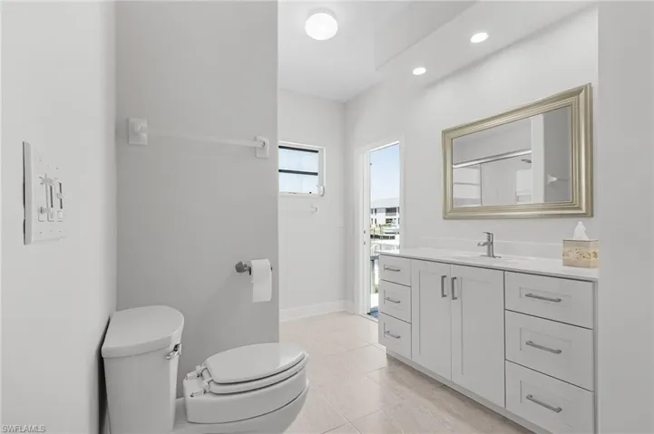 Bathroom with vanity, tile patterned floors, and recessed lighting