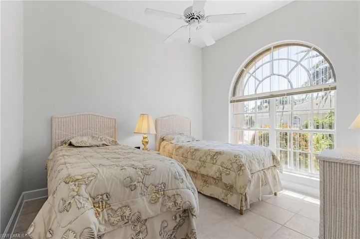 Bedroom featuring tile patterned flooring and ceiling fan