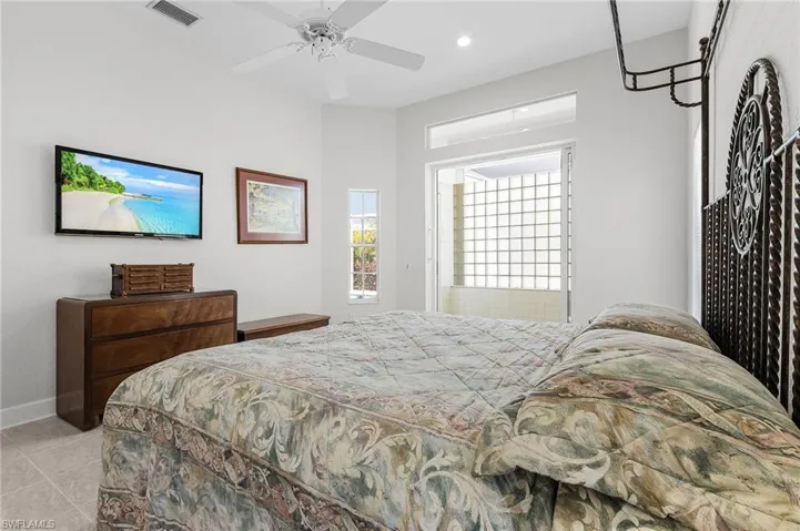 Bedroom with light tile patterned floors, recessed lighting, and a ceiling fan