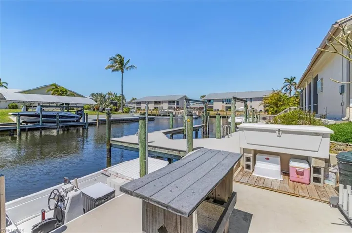 Dock with a water view, a residential view, and boat lift