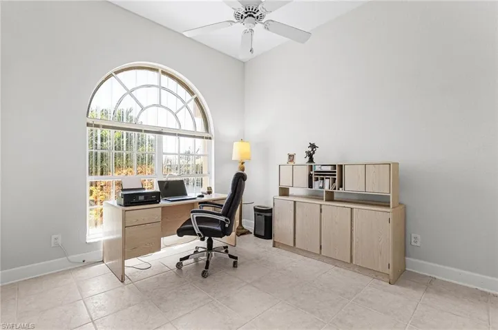 Office with ceiling fan and high vaulted ceiling