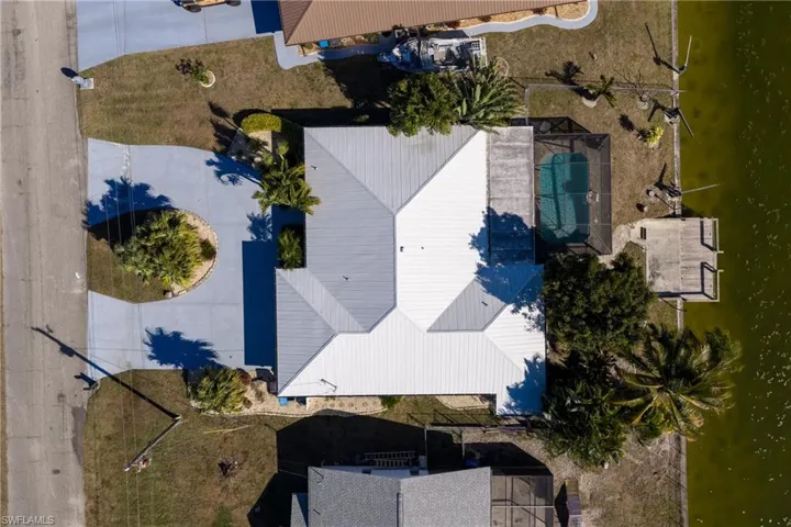 Bird's eye view of a nearby body of water and a pool area