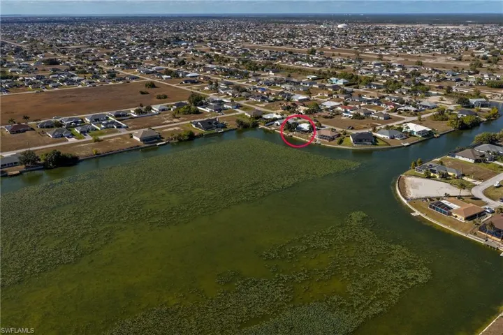 Aerial perspective of suburban area featuring a large body of water