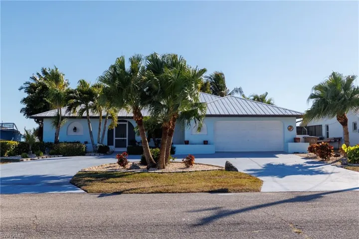 Ranch-style home featuring concrete driveway, stucco siding, and an attached garage