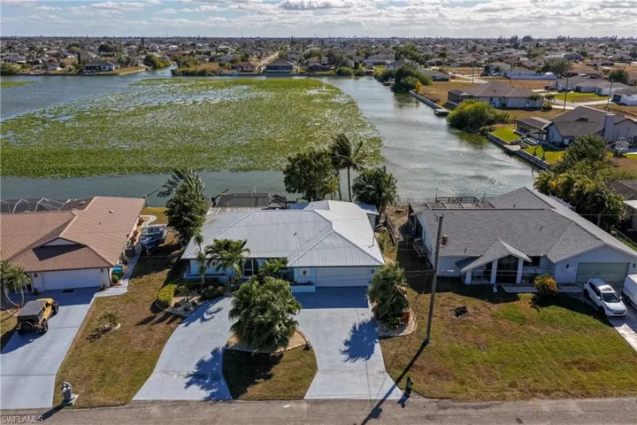 Aerial view of residential area featuring a large body of water
