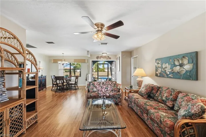 Living area with wood finished floors and ceiling fan
