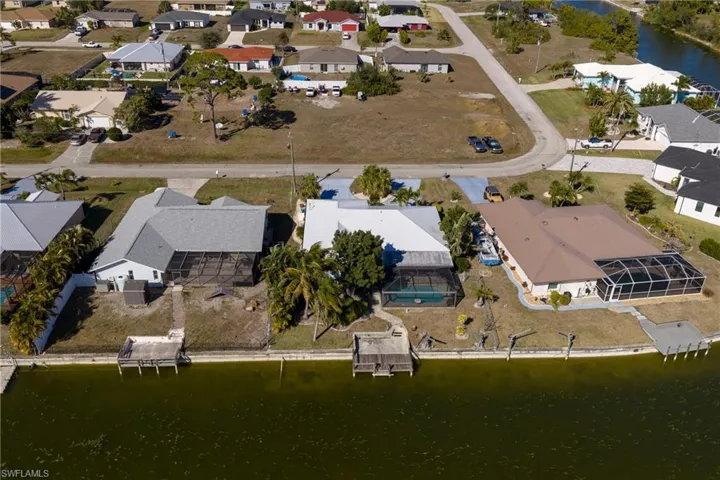 Aerial view of property's location featuring a large body of water and nearby suburban area