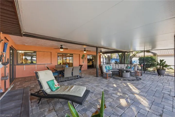 View of patio / terrace featuring an outdoor living / dining area and a ceiling fan