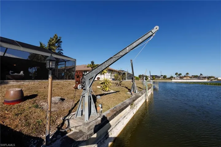 Dock area with a lanai and a water view