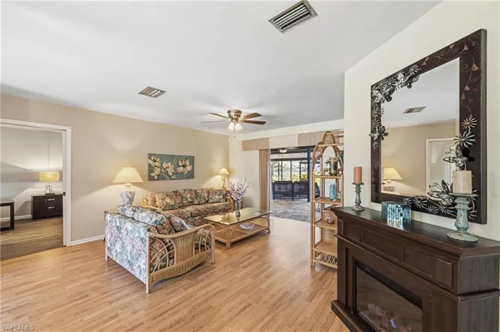 Living area featuring light wood-type flooring and ceiling fan